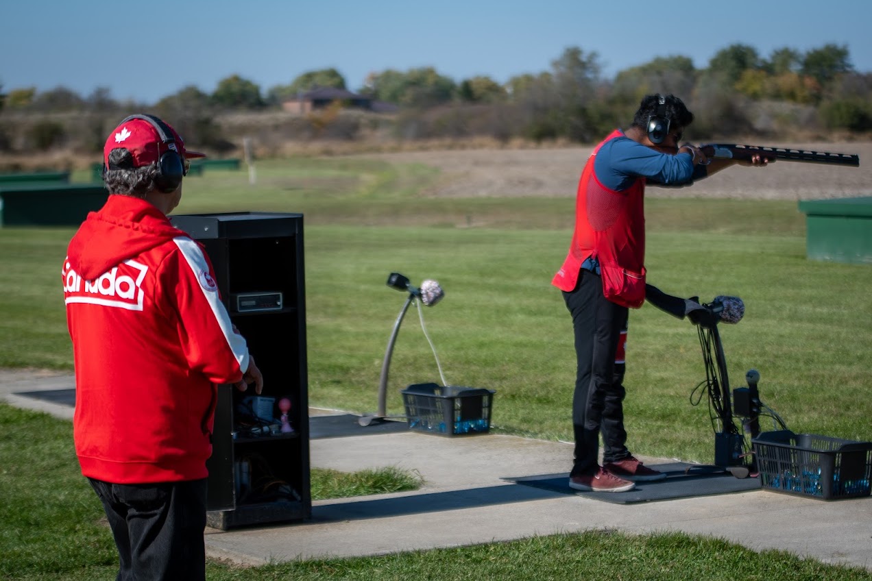 Academy coach observing an athlete during Olympic trapshooting training