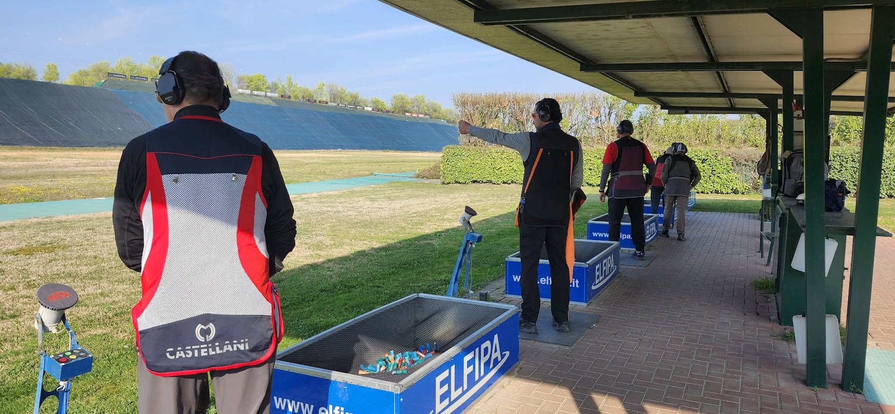 Athletes and coaches training on an international Olympic trap range in Lonato, Italy