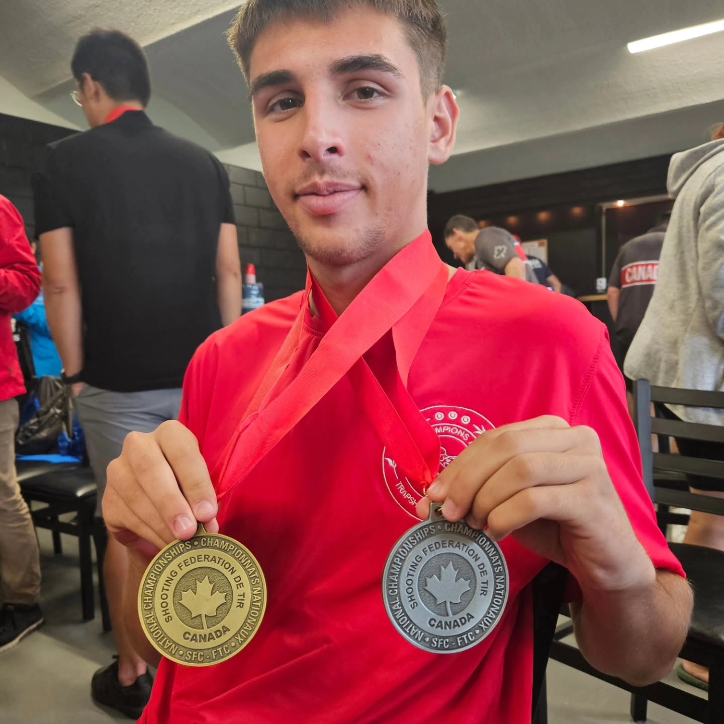 Trapshooting athlete displaying gold and silver Canadian National Championship medals